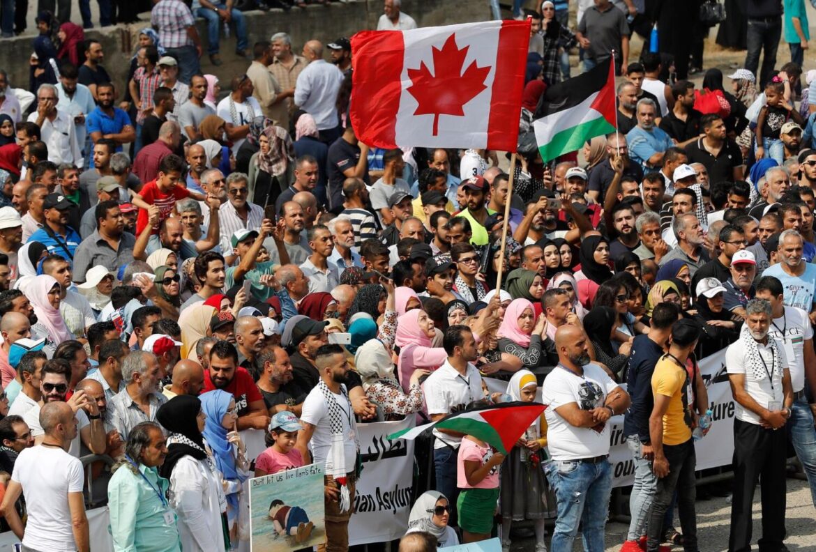 Hundreds of Palestinian refugees waving Palestinian and Canadian flags request asylum at a rally outside the the Canadian Embassy, in Beirut, Lebanon, Thursday, Sept. 5, 2019. People in the Gaza Strip who have Canadian relatives may apply for temporary visas to Canada, Canada’s immigration minister said Thursday, Dec. 21, 2023. Hundreds of Palestinian refugees waving Palestinian and Canadian flags request asylum at a rally outside the the Canadian Embassy, in Beirut, Lebanon, Thursday, Sept. 5, 2019. People in the Gaza Strip who have Canadian relatives may apply for temporary visas to Canada, Canada’s immigration minister said Thursday, Dec. 21, 2023.