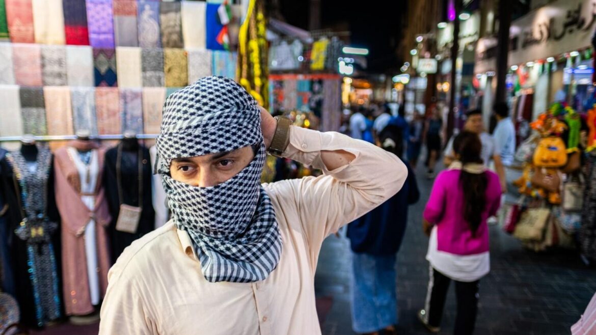A man wears Palestinian traditional scarf (Kefiyyeh) in Deira. - Photos by Shihab